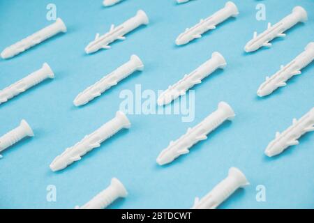 White dowels on blue background. Close up. Stock Photo