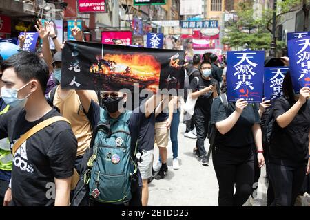 Hong Kong, S.A.R.China - 24 May, 2020 Pictured, protesters carry signs saying 'Heaven will destroy the CCP' during the Anti-Evil Law Parade against the proposed National Anthem Law and the newly announced National Security Law. Credit: Simon Jankowski/Alamy Live News Stock Photo