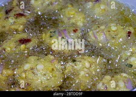 Fried cook of  Batate Vade, Batate Vadey, Fried Dhal Beans Cake or Kuih Vadey closeup. Indian traditional food. Selective focus Stock Photo