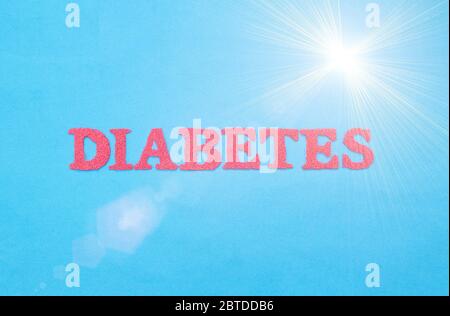 Word diabetes in red letters on a blue background. The concept of chronic endocrine disease in humans, treatment of type 1 and type 2 diabetes Stock Photo