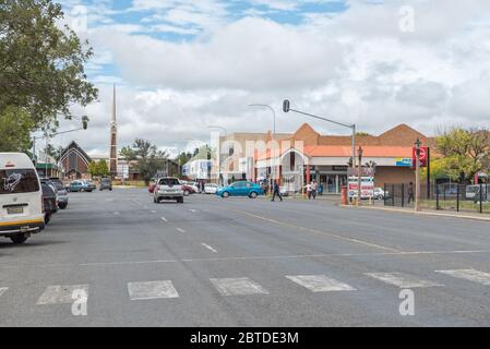 HARRISMITH, SOUTH AFRICA - MARCH 16, 2020:  A street scene, with businesses, vehicles, people and a church, in Harrismith Stock Photo