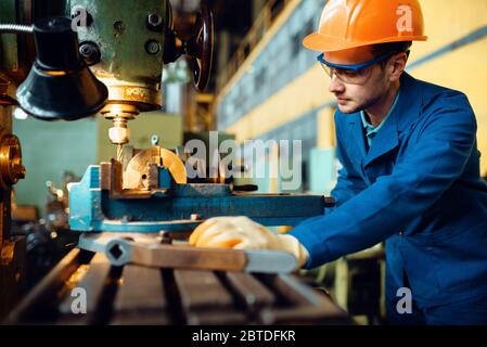 Male technician works on lathe, plant Stock Photo