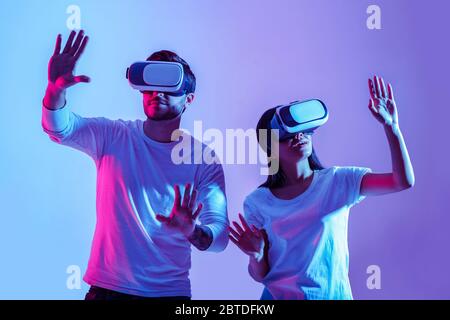 Digital world. Couple in virtual glasses make hands movements Stock Photo