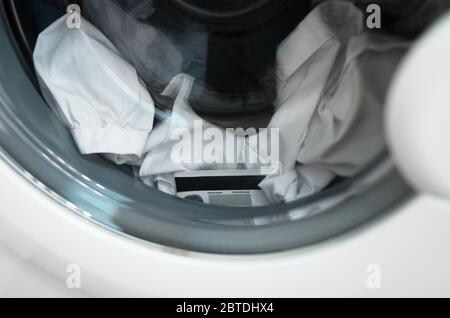 Forgotten credit card in the washing machine. Stock Photo