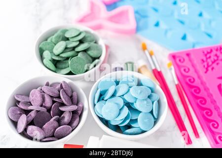 Flat lay. Ingredients to make chocolate mermaid molds from the chocolate chips. Stock Photo