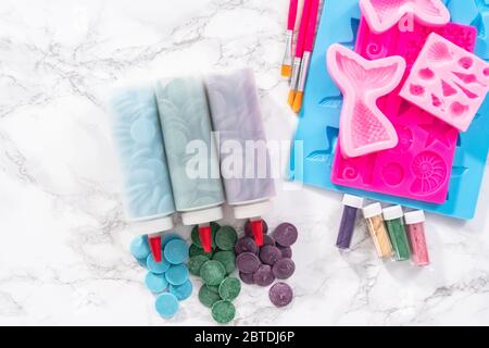 Flat lay. Ingredients to make chocolate mermaid molds from the chocolate chips. Stock Photo
