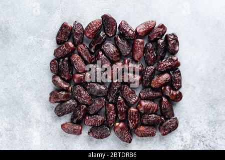 Dried dates on concrete background. Date fruit Stock Photo