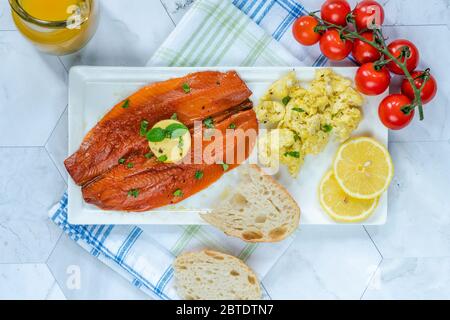 Smoked kipper brunch with scrambled egg and tomatoes - overhead view Stock Photo