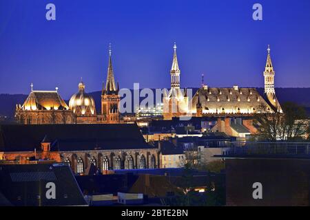 illuminated towers of the cathedral and town hall of Aachen in the evening, Germany, North Rhine-Westphalia, Aix-la-Chapelle Stock Photo