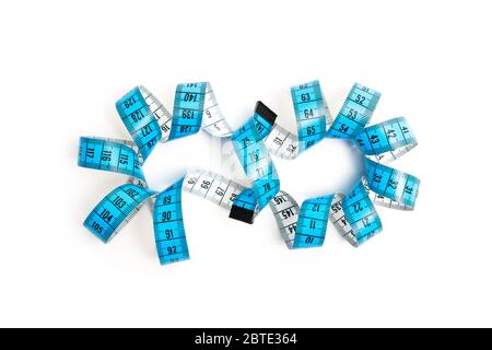 A object about Sewing measuring tape with eternity shape on a isolated white background. Sewing and tailoring concept Stock Photo