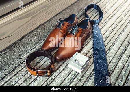 Groom's brown shoes, blue tie, belt and cufflinks Stock Photo