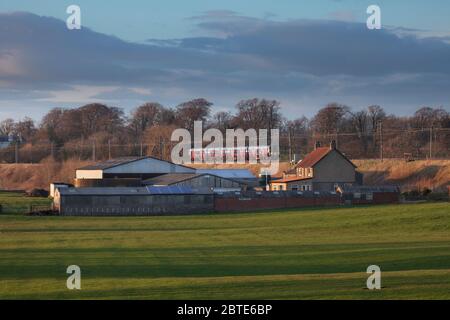 First Transpennine Express class 350 electric train 350409 passing a farm on the west coast mainline in Lancashire Stock Photo