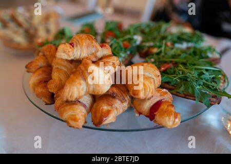 freshly baked croissants on grey wooden table. Stock Photo