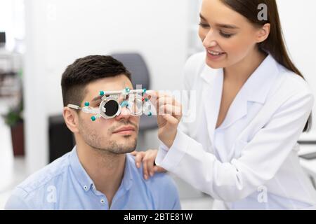 Optometrist checking patients vision with trial frame Stock Photo