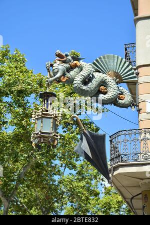 BARCELONA, SPAIN - AUGUST 10, 2015 : Chinese dragon on Casa Bruno Cuadros, that was an umbrella shop. Building is located on La Rambla Stock Photo
