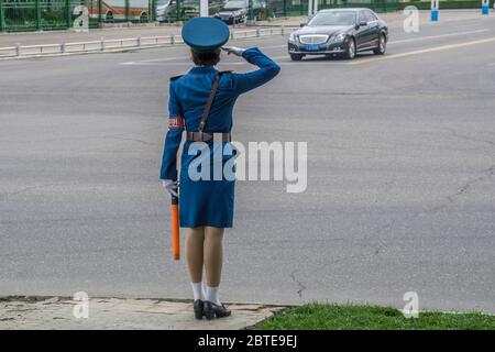 North Korean traffic security officer in blue uniform in the street, Pyongan Province, Pyongyang, North Korea Stock Photo