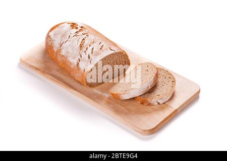 Loaf Of Bread On A Cutting Board Isolated On White Stock Photo