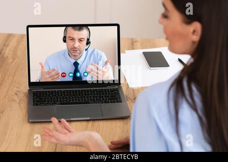 Workers having discussion during video call at home Stock Photo