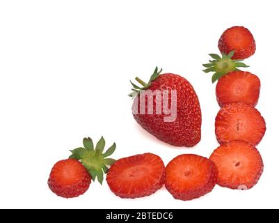 Isolated strawberries. One whole fruit and cut berries on white background Stock Photo