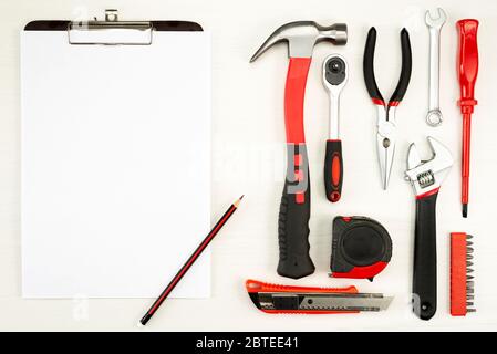 large set of construction tools with a sheet of white paper with a pencil on a white background, top view Stock Photo