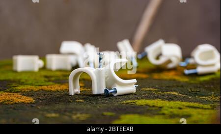 Close up of iron nails for cable support on the wall Stock Photo