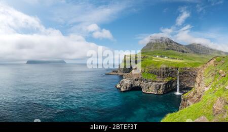 Incredible day view of Mulafossur waterfall in Gasadalur village, Vagar Island of the Faroe Islands, Denmark. Landscape photography Stock Photo