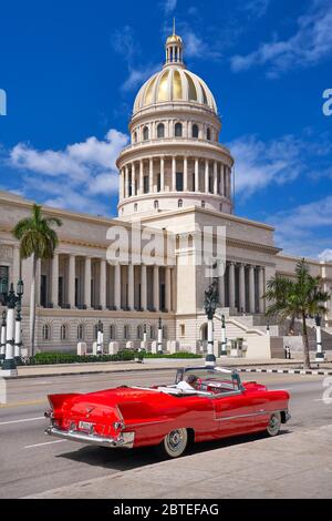National Capitol Building and old red American Car, Havana, Cuba Stock Photo