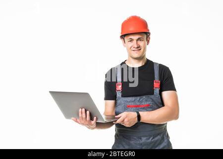 Full body view of a construction contractor working on his laptop isolated on white background Stock Photo