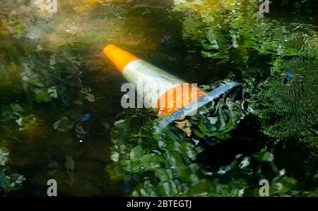 London, UK. 25th May 2020 Traffic Cone Pollution in The Duke of Northumberland River (Thames Tributary), behind Twickenham Rugby Ground. Andrew Fosker / Alamy Live News Stock Photo