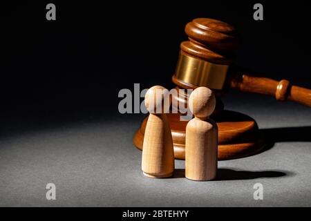 Wooden toy family and judge mallet. Family divorce concept Stock Photo