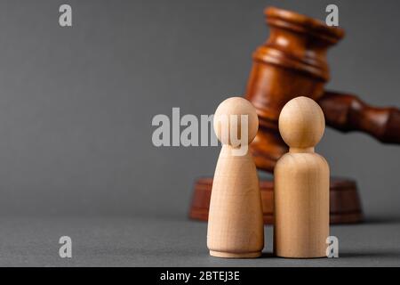 Wooden toy family and judge mallet. Family divorce concept Stock Photo