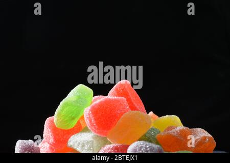Close up photo of colorful gummy candies against dark background Stock Photo