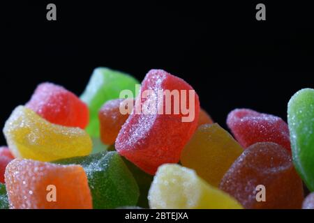Close up photo of colorful gummy candies against dark background Stock Photo