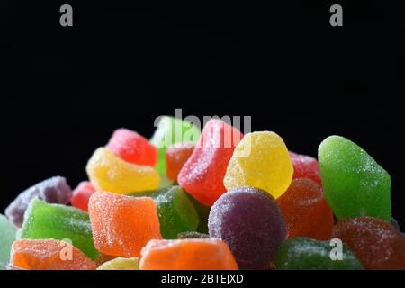 Close up photo of colorful gummy candies against dark background Stock Photo