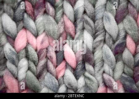 Knitted fabric of very thick yarn. A big tangle. The background is