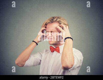 Stressed anxious young man feeling overwhelmed Stock Photo