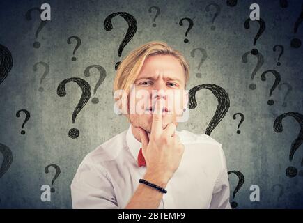 Confused young man with too many questions and no answer Stock Photo