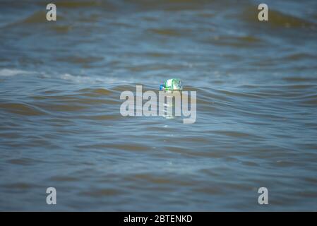 Plastic water bottle floating on the ocean Stock Photo