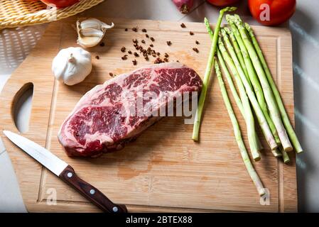 Wagyu Japanese beef steak on the cutting board with vegetables