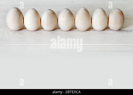 Wooden Easter eggs are not painted lined up. Stock Photo