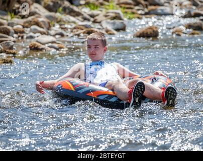 Krystin Slaby enjoys the hot weather on the River Wharfe in Burnsall, Yorkshire, as people flock to parks and beaches with lockdown measures eased. Stock Photo