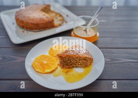 Homemade orange cake on a dark wooden kitchen table. Vegan and Gluten Free Stock Photo