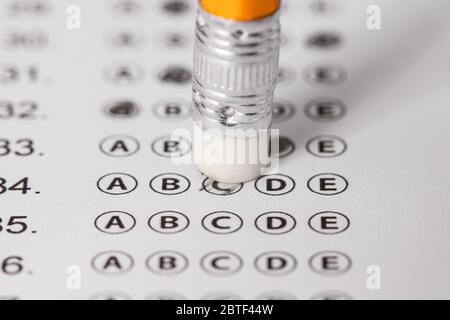 written mistake on a piece of paper, delete, correct, and mistake concept. Take the exam, write the exam. Stock Photo