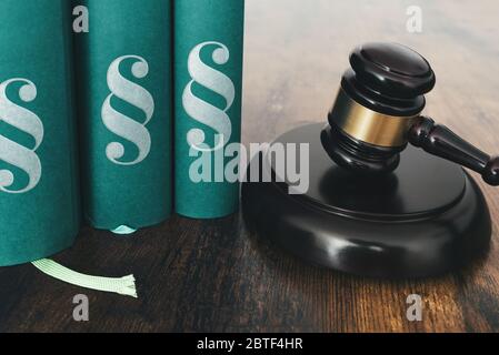 close-up of judges gavel and law books on rustic wooden table Stock Photo