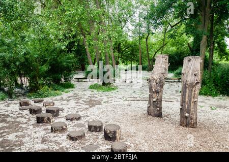 Children’s play area,  kids enjoying a lovely Spring day, with glorious blue skies in Morden Hall Park Stock Photo