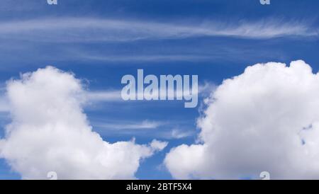 Unusual cloud formation offering copy space on clouds against blue sky Stock Photo