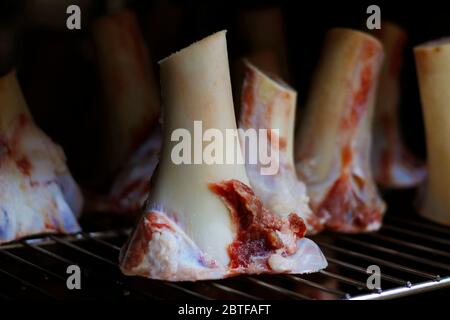 veal marrow bone  arranged on a metal rack for roasting to make sauces Stock Photo