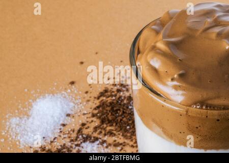 Dalgon iced coffee in transparent glass. Korean and Indian whipped coffee. Foam macro, close up. Stock Photo