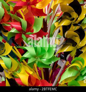 Rainbow colored pinwheels toys. Pinwheel background Stock Photo