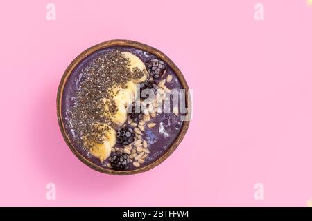 Superfood blackberry avocado smoothie bowl on pastel pink background. Image with copy space, top view Stock Photo